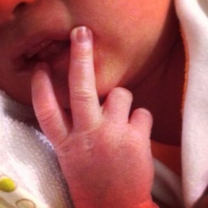 2 fingers - no photos please mummy!