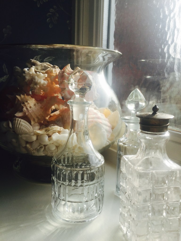 shells and glass bottles in bathroom