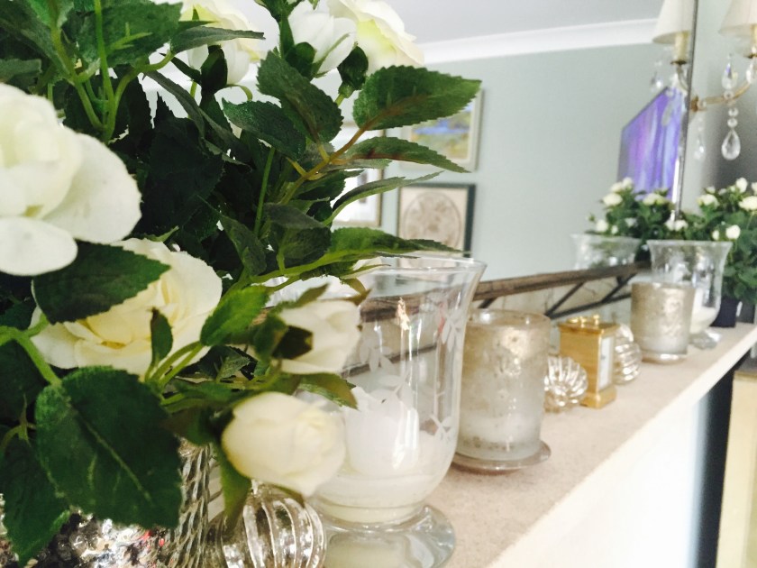 flowers and candles on mantelpiece