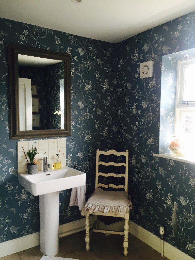 bathroom with beautiful wallpaper and tiles