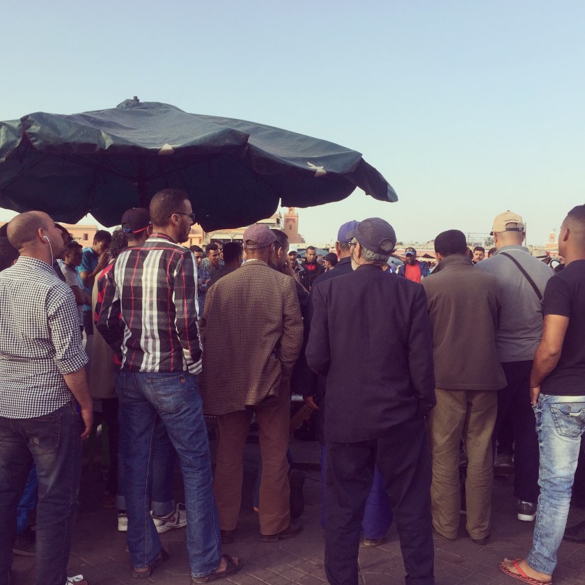 Moroccan locals gathered round the storyteller