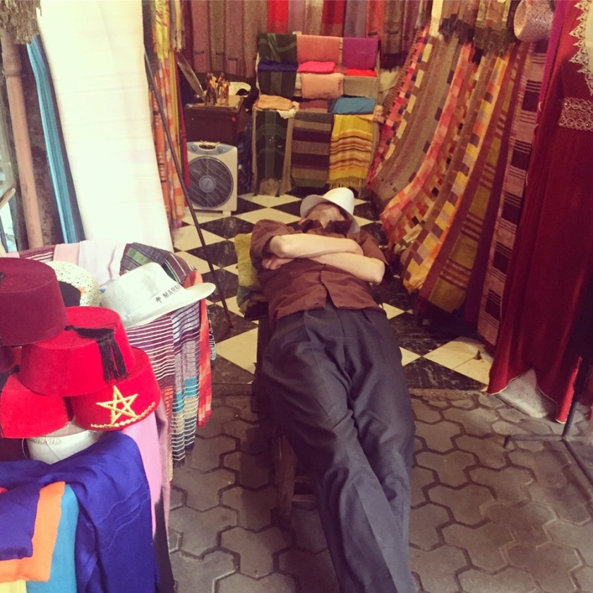 Man sleeping in his souk stall Marrakesh 